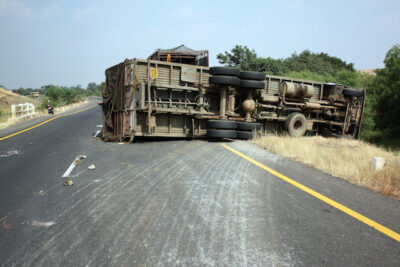 Truck rollover crash on side of the road