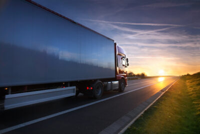 18 wheeler truck driving during sunset